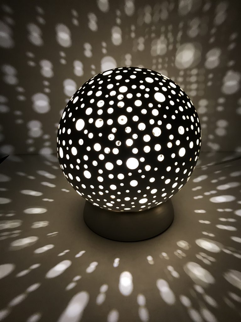 spherical lamp with small circles cut out.