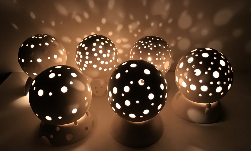 spheres with hole in them through which light is pouring